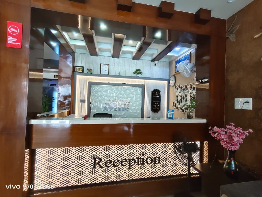 Close-up of premium wood finished reception desk with helpful staff desk at Hotel Park Avenue Sikar